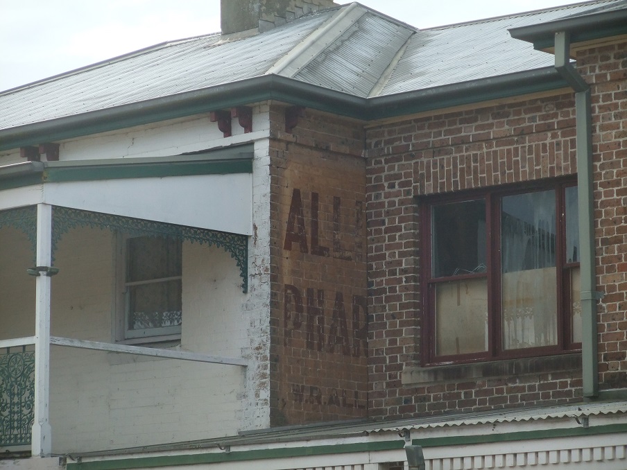 A portion of the advertising sign for Allison’s Pharmacy still visible on the side of the building in Windsor Street Richmond NSW